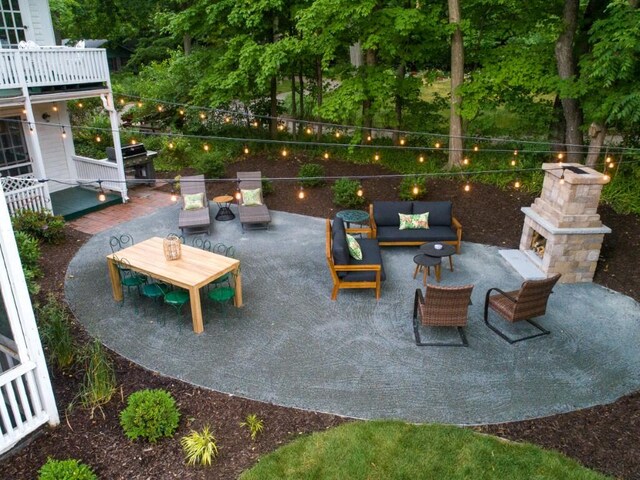 view of patio with an outdoor living space with a fireplace