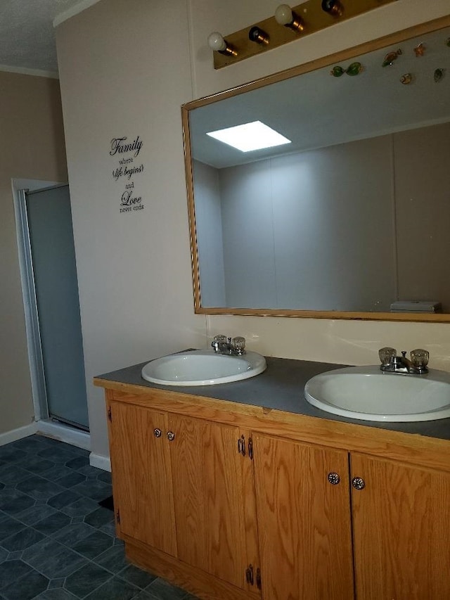 bathroom with tile patterned flooring, vanity, a shower with shower door, and ornamental molding