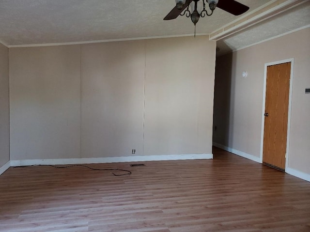 empty room with a textured ceiling, light wood-type flooring, ceiling fan, and crown molding