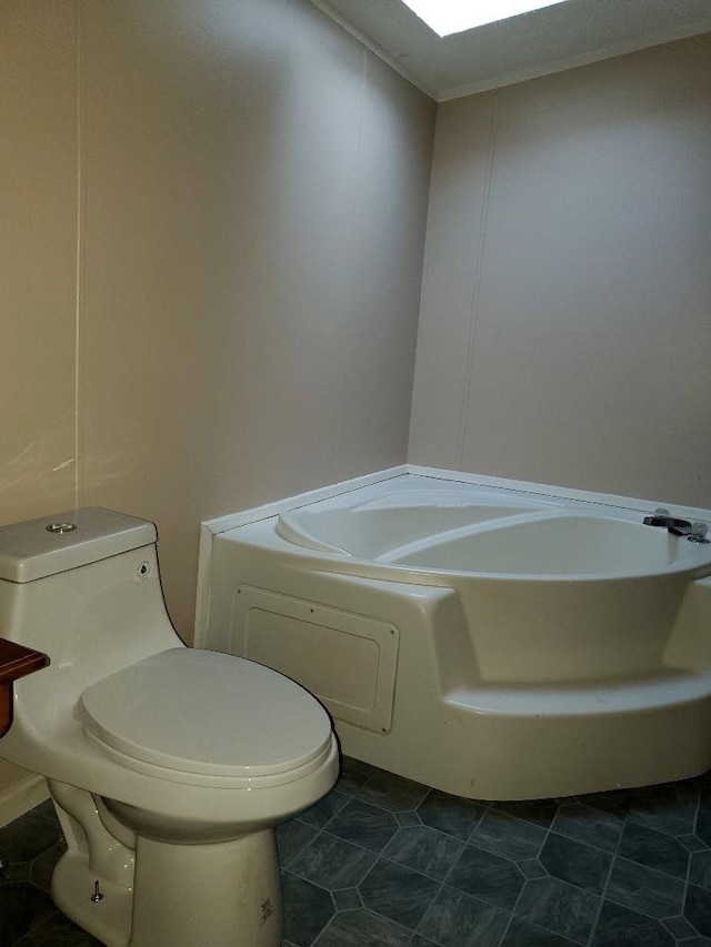 bathroom with tile patterned floors, a bathing tub, and toilet