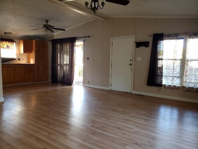 unfurnished living room featuring hardwood / wood-style floors, vaulted ceiling with beams, and ceiling fan