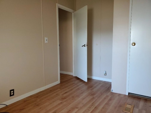 unfurnished bedroom with light wood-type flooring