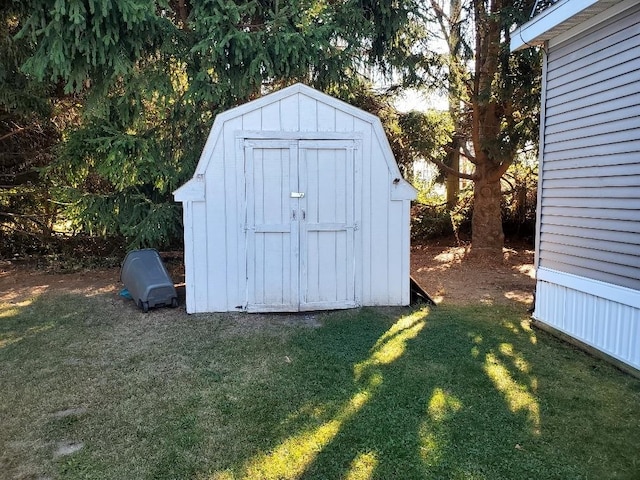 view of outbuilding featuring a yard