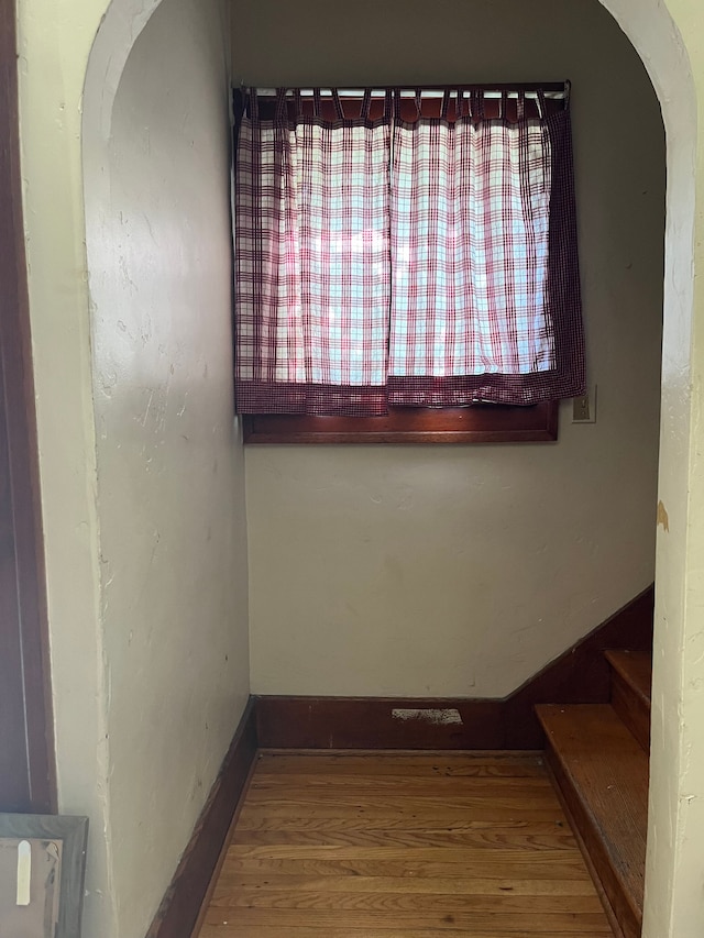 unfurnished room with wood-type flooring