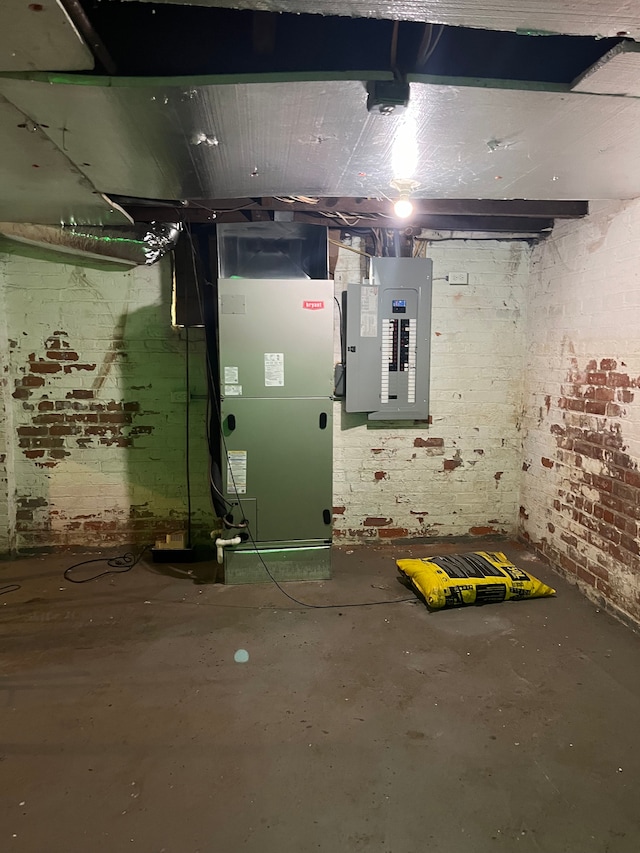 utility room with electric panel and heating unit