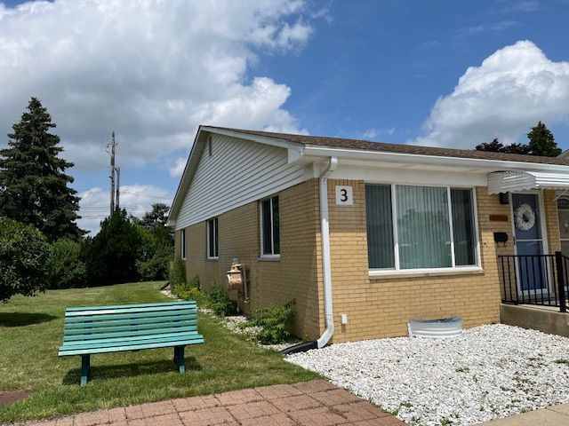 view of side of home with a lawn