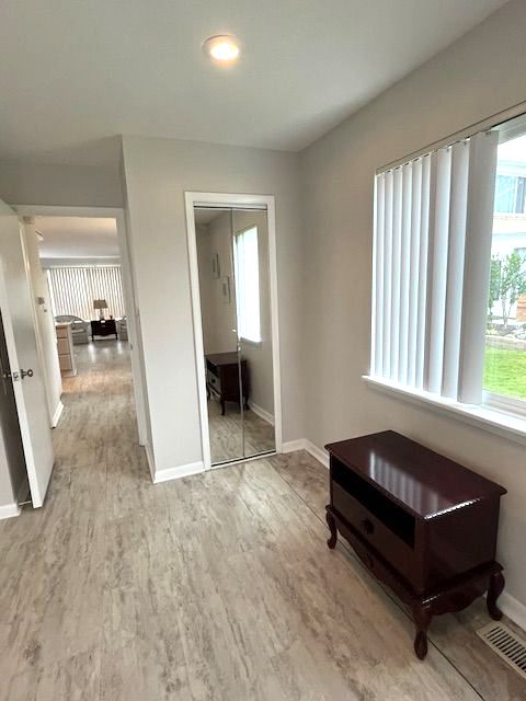 hallway with light hardwood / wood-style flooring