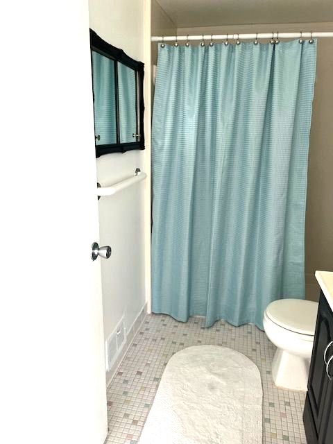 bathroom with tile patterned floors, vanity, and toilet