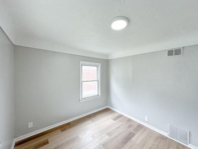 spare room featuring light hardwood / wood-style flooring