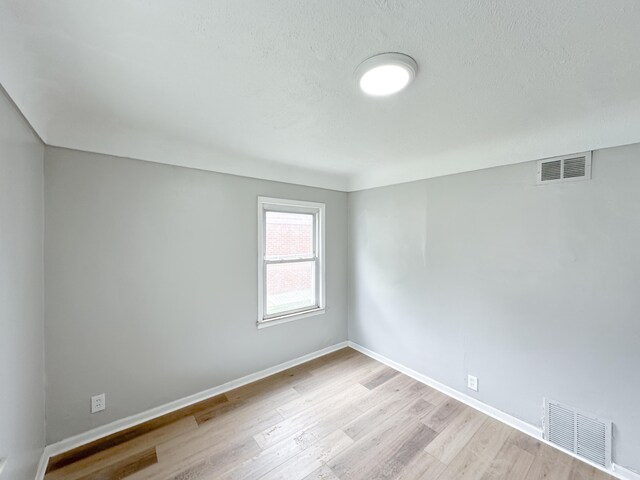27022 Colgate St, Inkster, MI 48141 - empty room featuring light wood finished floors, baseboards, and a textured ceiling