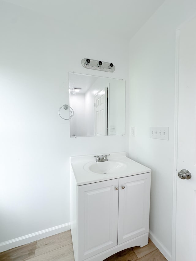 bathroom featuring hardwood / wood-style floors and vanity