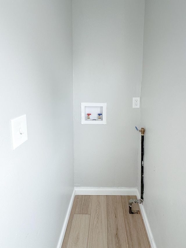 laundry room featuring washer hookup and hardwood / wood-style flooring