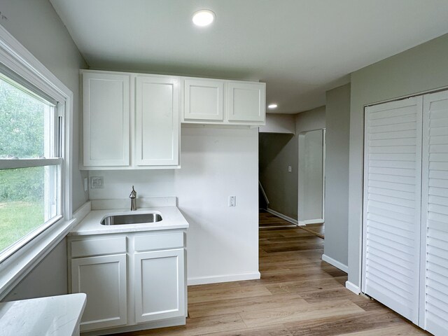 27022 Colgate St, Inkster, MI 48141 - kitchen with a sink, white cabinetry, light countertops, baseboards, and recessed lighting