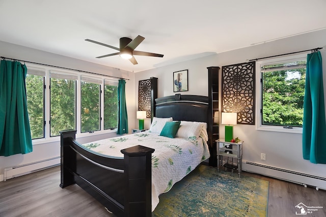 bedroom with dark wood-type flooring, a baseboard radiator, and ceiling fan