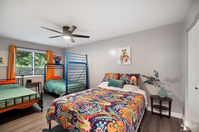 bedroom with ceiling fan and hardwood / wood-style floors