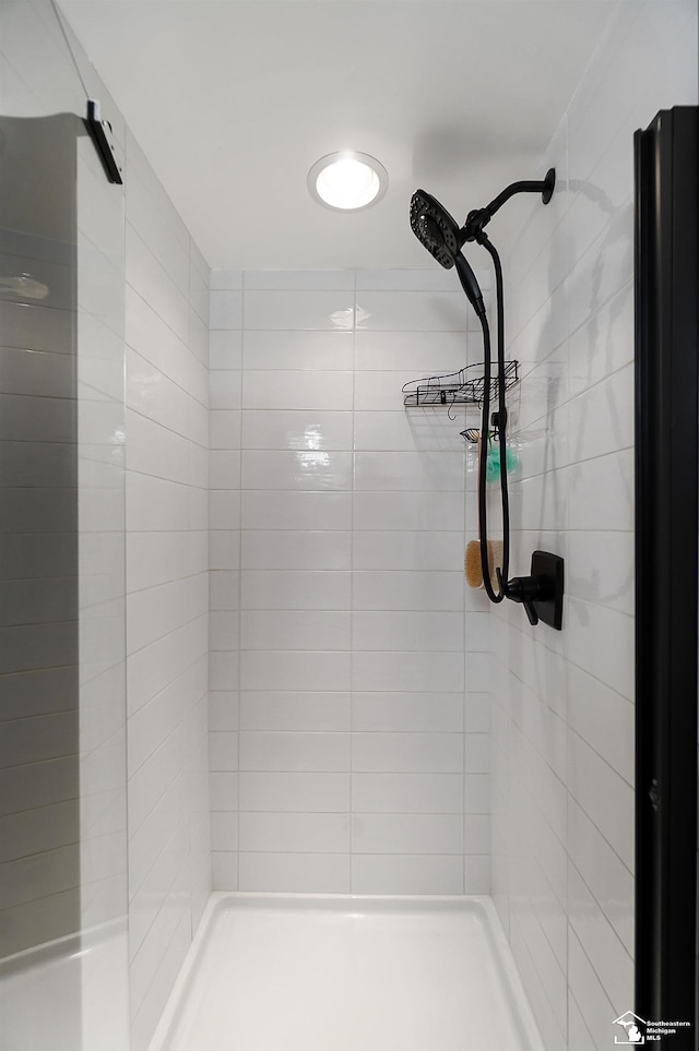 bathroom with a tile shower