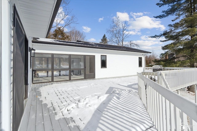 wooden deck with a sunroom