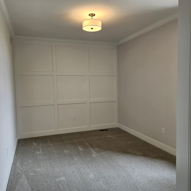 spare room with ornamental molding and carpet floors