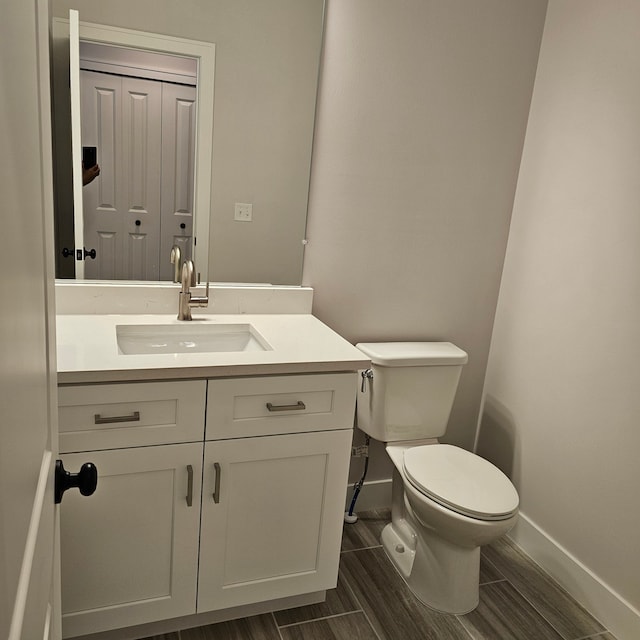 bathroom with toilet and vanity