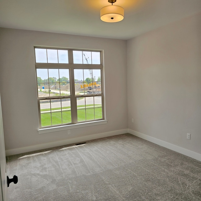 unfurnished room with carpet flooring