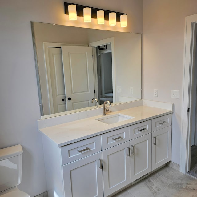 bathroom featuring toilet and vanity