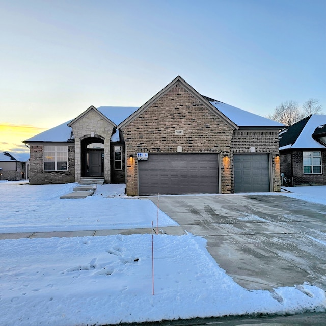 french provincial home featuring a garage