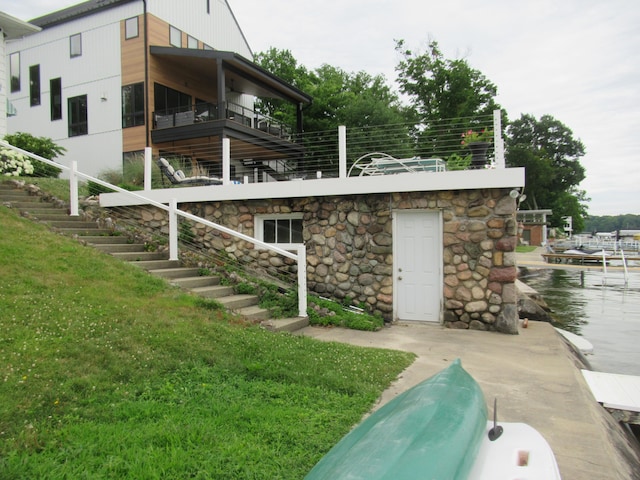 exterior space featuring a balcony and a lawn