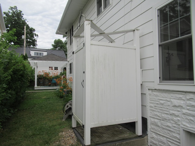 view of side of home with a lawn