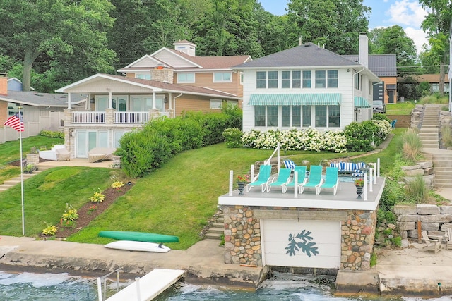 rear view of house featuring a yard