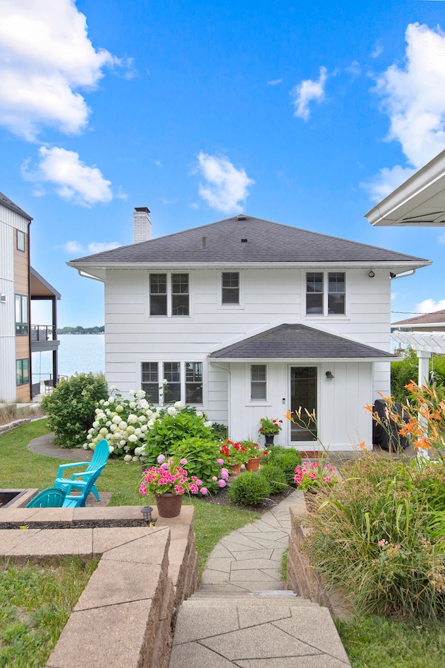 rear view of property featuring a water view