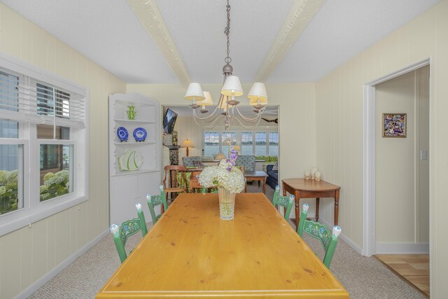 21945 Howell Dr, Cassopolis, MI 49031 - carpeted dining area featuring a chandelier, baseboards, beamed ceiling, and a textured ceiling
