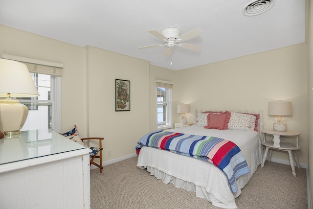 bedroom with ceiling fan and light colored carpet