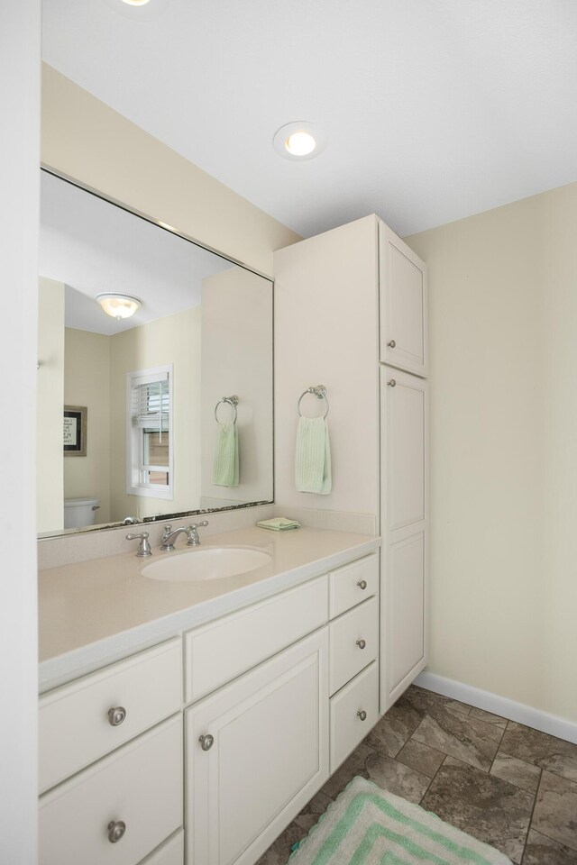 21945 Howell Dr, Cassopolis, MI 49031 - bathroom featuring vanity, baseboards, and toilet
