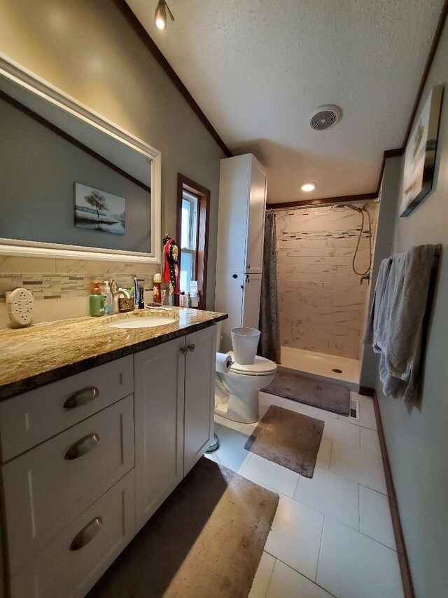 5232 E Broadway, Mount Pleasant, MI 48858 - full bath featuring vanity, tiled shower, toilet, tile patterned flooring, and a textured ceiling