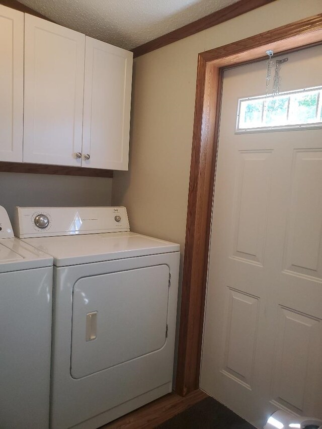 5232 E Broadway, Mount Pleasant, MI 48858 - washroom featuring washer and clothes dryer, cabinet space, and a textured ceiling