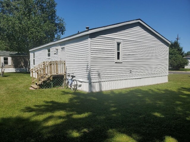 5232 E Broadway, Mount Pleasant, MI 48858 - back of house featuring a yard