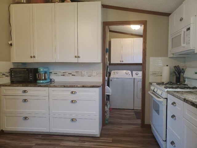 5232 E Broadway, Mount Pleasant, MI 48858 - kitchen with white appliances, washing machine and clothes dryer, lofted ceiling, tasteful backsplash, and dark wood-style floors