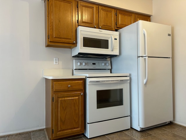 kitchen with tile patterned flooring and white appliances