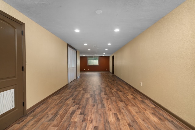 unfurnished room with dark wood-type flooring