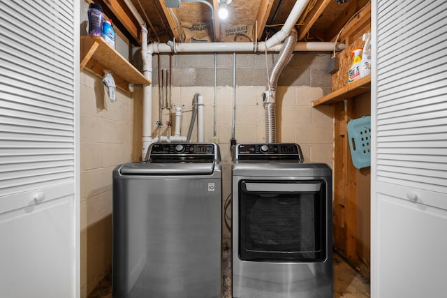 clothes washing area with washing machine and dryer