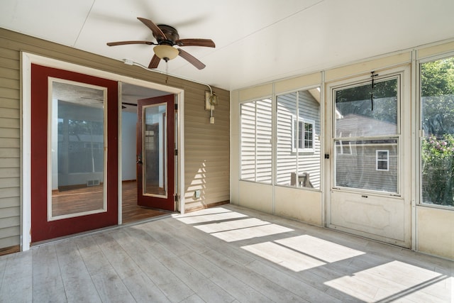 unfurnished sunroom with ceiling fan and plenty of natural light