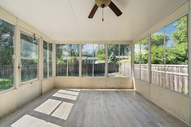 unfurnished sunroom with ceiling fan