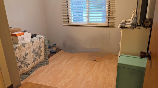 bedroom with washer / clothes dryer and hardwood / wood-style flooring