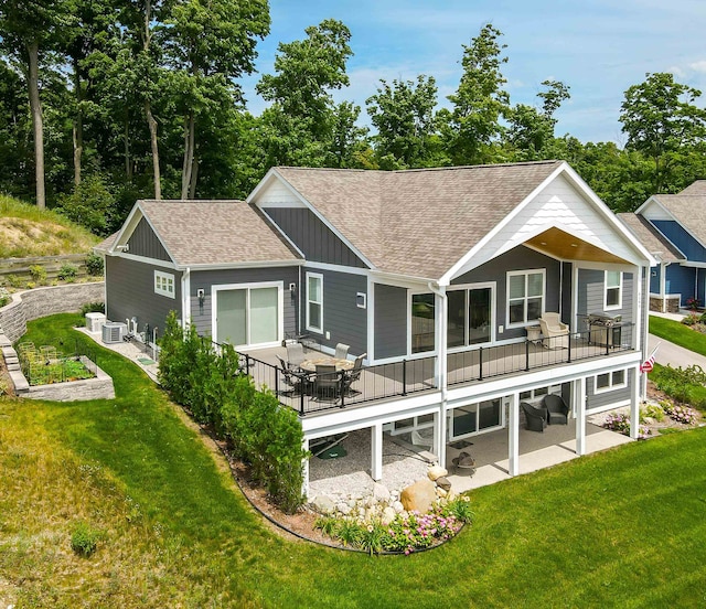 back of property featuring a patio area, a yard, and central air condition unit