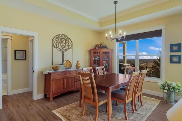 dining area featuring wood-type flooring and a notable chandelier