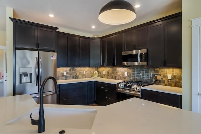 kitchen featuring decorative backsplash, sink, dark brown cabinets, and stainless steel appliances