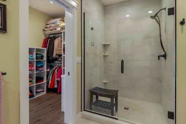 bathroom featuring an enclosed shower and hardwood / wood-style flooring