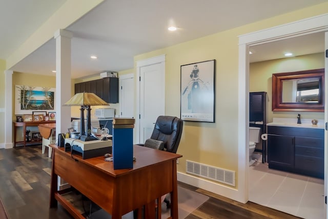 office space featuring dark hardwood / wood-style floors and sink