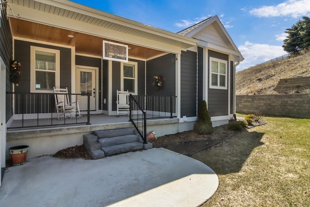 view of exterior entry with covered porch