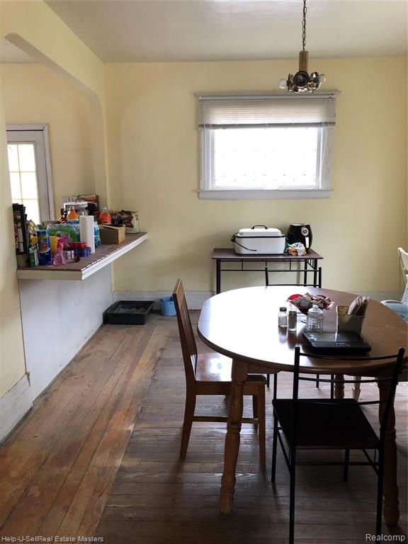 dining room with plenty of natural light and wood-type flooring